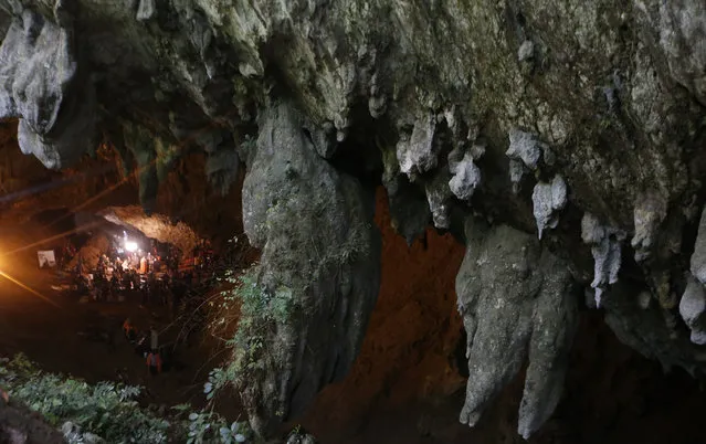 Emergency rescue teams gather in the staging area as they continue the search for 12 young soccer team members and their coach after going missing in a large cave in Mae Sai, Chiang Rai province, in northern Thailand Wednesday, June 27, 2018. (Photo by Sakchai Lalit/AP Photo)