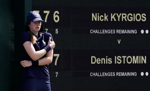 A ball girl reacts after she was hit by a serve from Australia's Nick Kyrgios during the first round match against Uzbekistan's Denis Istominh on the second day of the 2018 Wimbledon Championships at The All England Lawn Tennis Club in Wimbledon, southwest London, on July 3, 2018. (Photo by Peter Nicholls/Reuters)