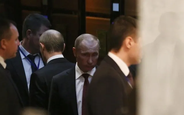 Russia's President Vladimir Putin (C) uses an elevator as he attends a peace summit to resolve the Ukrainian crisis in Minsk, February 12, 2015. (Photo by Vasily Fedosenko/Reuters)