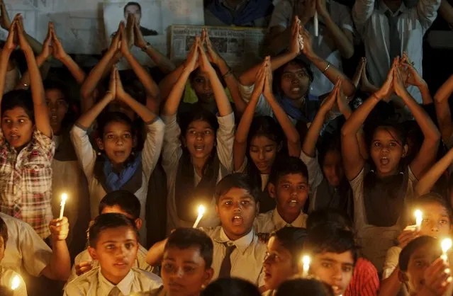 Students hold candles as they take part in a special prayer ceremony for the victims of a militant attack at Pathankot air base, at a school in Ahmedabad, India, January 5, 2016. Indian security forces have killed six militants who launched an assault on a military air base in northern India that killed seven security personnel and injured 22, Defence Minister Manohar Parrikar said on Tuesday. (Photo by Amit Dave/Reuters)