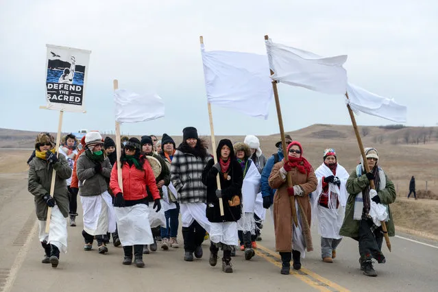 Women march to Backwater Bridge during a protest against plans to pass the Dakota Access pipeline near the Standing Rock Indian Reservation, near Cannon Ball, North Dakota, U.S. November 27, 2016. (Photo by Stephanie Keith/Reuters)