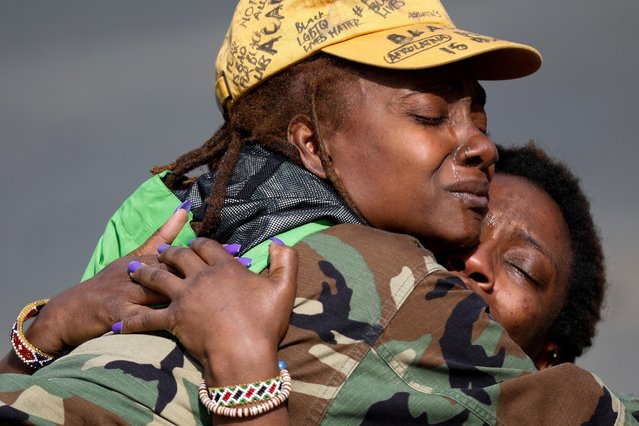 Phoenix Robles and Dorcas Monari hug during a demonstration in front of the Brooklyn Center Police Department as protests continue days after former police officer Kim Potter fatally shot Daunte Wright, in Brooklyn Center, Minnesota, April 18, 2021. (Photo by Nick Pfosi/Reuters)