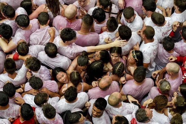 Participants gather before the “Chupinazo” (start rocket) opening ceremony to mark the kick-off of the San Fermin bull Festival outside the Town Hall of Pamplona in northern Spain on July 6, 2023. Thousands of people every year attend the week-long festival and its famous “encierros'” six bulls are released at 8:00 a.m. evey day to run from their corral to the bullring through the narrow streets of the old town over an 850 meters (yard) course while runners ahead of them try to stay close to the bulls without falling over or being gored. (Photo by Miguel Riopa/AFP Photo)