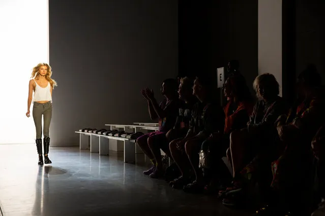 Designer Jeremy Scott and members of his team watch a model practice a run through before the Jeremy Scott Spring/Summer 2019 collection during New York Fashion Week in the Manhattan borough of New York City, U.S., September 6, 2018. (Photo by Caitlin Ochs/Reuters)