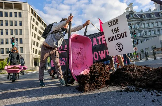 Extinction Rebellion DC dumps cow manure at the entrance to the White House on Earth Day to protest President Biden's climate plan in Washington, U.S., April 22, 2021. (Photo by Evelyn Hockstein/Reuters)