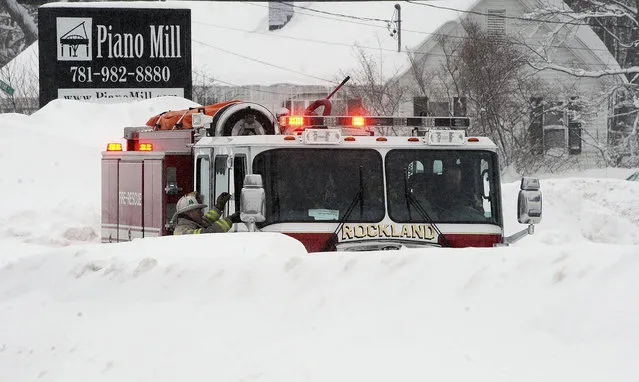 A Rockland, Mass., firetruck sits outside the Piano Mill music store after its roof partially collapsed into the showroom from the weight of 29 inches of new snow Tuesday, February 10, 2015, in Rockland, Mass. (Photo by Marc Vasconcellos/AP Photo/The Brockton Enterprise)