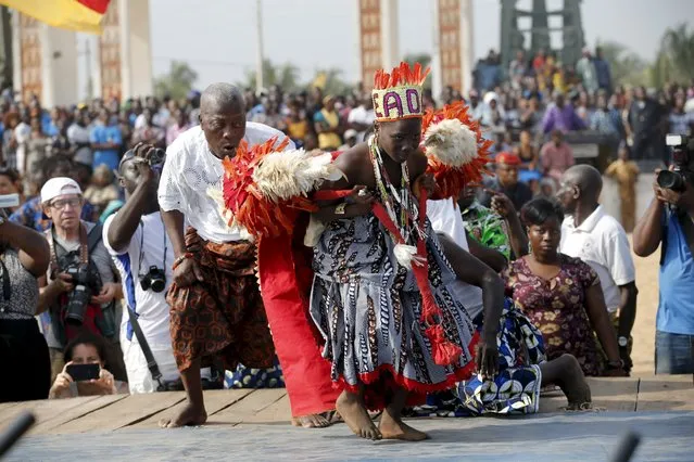 A devotee is guided as he dances on a stage at the annual voodoo festival in Ouidah January 10, 2016. (Photo by Akintunde Akinleye/Reuters)