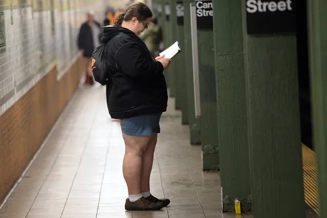 A participant in the "No Pants Subway Ride"  stands on a New York City subway platform January 10, 2016 in New York. (Photo by Timothy A. Clary/AFP Photo)