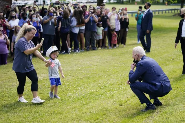 President Joe Biden stops outside at York High School and is greeted by a child and his mother, Monday, May 3, 2021, in Yorktown, Va. (Photo by Evan Vucci/AP Photo)
