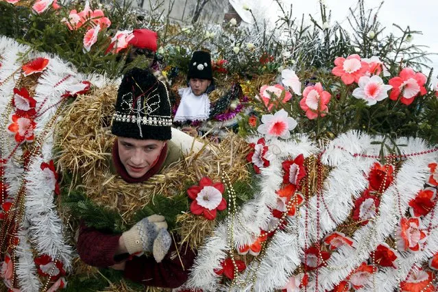 Local residents dressed in costumes perform during celebrations for the Malanka holiday in the village of Krasnoilsk in the Chernivtsi region of Ukraine, January 14, 2016. The Malanka traditional holiday is more popular in the western regions of the country and is also known as the Old New Year celebrated on January 13 and 14 - St. Basil's and St. Melania's Day, according to the old Julian calendar. During the celebrations, youngsters and adults wear traditional carnival costumes and masks, and visit local houses while singing carols, playing pranks or performing short plays. (Photo by Valentyn Ogirenko/Reuters)