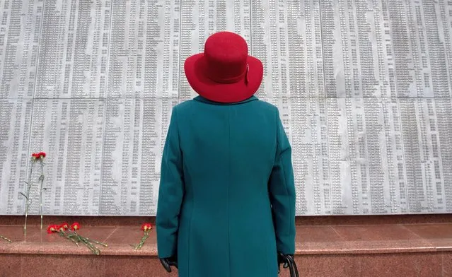 A woman stands in front of a World War Two memorial during a ceremony on Victory Day, which marks the 76th anniversary of the victory over Nazi Germany, in Tomsk, Russia on May 9, 2021. (Photo by Taisiya Vorontsova/Reuters)