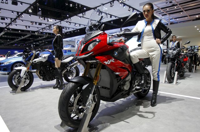 A model poses on a BMW S1000 XR during a media presentation of the 36th Bangkok International Motor Show in Bangkok March 24, 2015. (Photo by Chaiwat Subprasom/Reuters)