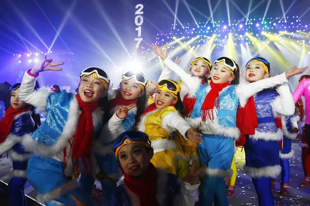Performers gather and pose for photograph as they attend the count down event to celebrate the arrival 2017 new year during New Year's Eve celebration at Beijing Olympic Park in Beijing city, China, 01 January 2017.  (Photo by Wu Hong/EPA)