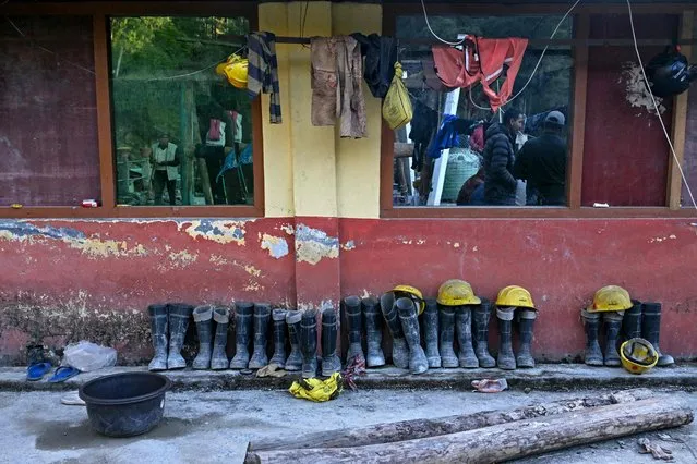Shoes of excavators are seen at a shelter house, during a rescue operation to free workers trapped in the Silkyara under construction road tunnel, days after it collapsed in the Uttarkashi district of India's Uttarakhand state on November 22, 2023. Indian rescuers have drilled two-thirds of the way through debris towards 41 workers trapped in a collapsed road tunnel, officials said on November 22, warning that the next 24 hours could be critical. (Photo by Arun Sankar/AFP Photo)