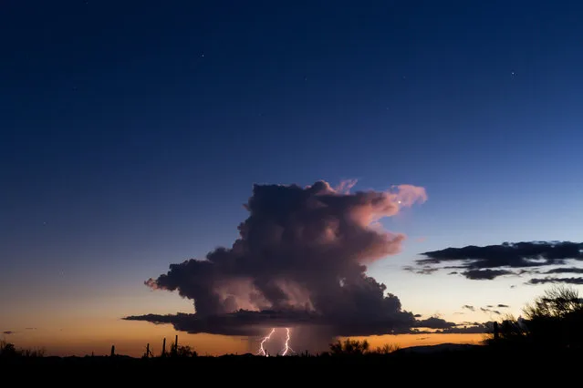A beautiful, isolated storm hangs in western portions of Arizona right at sunset in Arizona, USA, 9 August 2016. (Photo by Mike Olbinski/Barcroft Images)