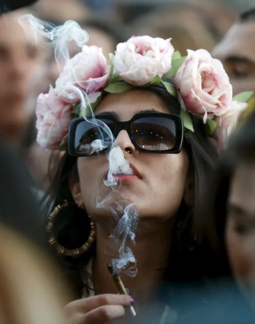 A woman smokes at the Coachella Valley Music and Arts Festival in Indio, California April 10, 2015. (Photo by Lucy Nicholson/Reuters)