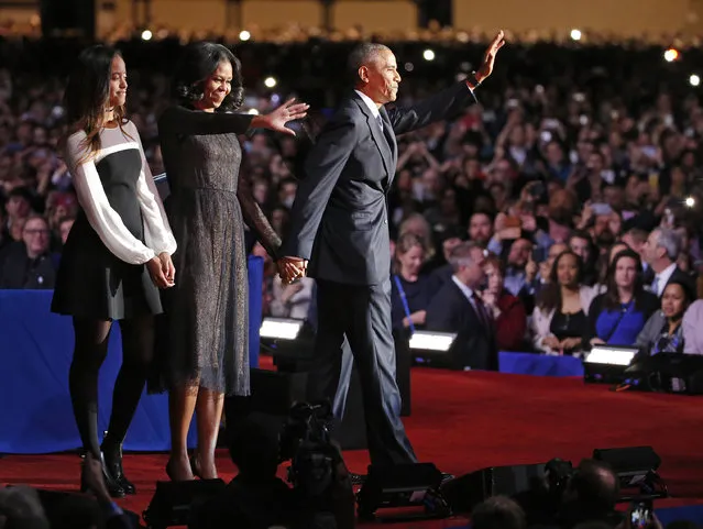President Barack Obama waves as he is joined by First Lady Michelle Obama and daughter Malia Obama after giving his presidential farewell address at McCormick Place in Chicago, Tuesday, January 10, 2017. (Photo by Nam Y. Huh/AP Photo)