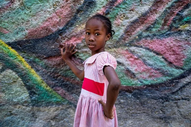 A girl poses for a photo in Port-au-Prince, Haiti on July 17, 2021. (Photo by Ricardo Arduengo/Reuters)