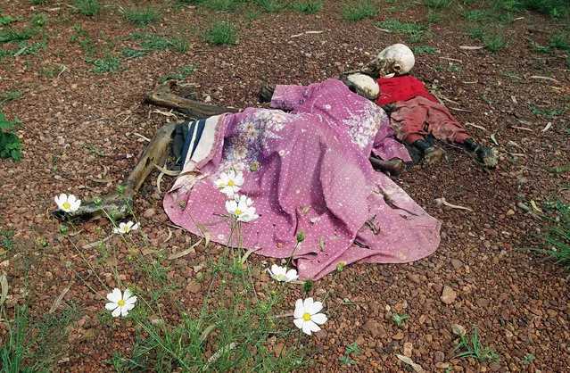In this May 31, 1994, file photo, the bodies of a woman and her child lie by a church in Nyarubuye parish, which was the site of an April 14 massacre that survivors say was perpetrated by a militia assisted by government gendarmes, about 95 miles east of the capital Kigali, in Rwanda. A commission that spent nearly two years uncovering France's role in 1994's Rwandan genocide concluded Friday, March 26, 2021 that the country reacted too slowly in appreciating the extent of the horror that left over 800,000 dead and bears “heavy and overwhelming responsibilities” in the drift that led to the killings, but cleared the country of any complicity in the slaughter that mainly targeted Rwanda's Tutsi ethnic minority. (Photo by Jean-Marc Bouju/AP Photo/File)