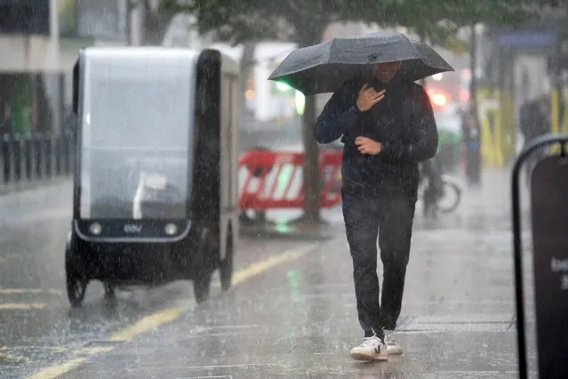 People walk in the rain near the Home Office in central London on Tuesday, November 14, 2023. A week's worth of rain could fall in just a few hours across parts of the UK on Tuesday as wet weather continues to batter the country. (Photo by James Manning/PA Images via Getty Images)