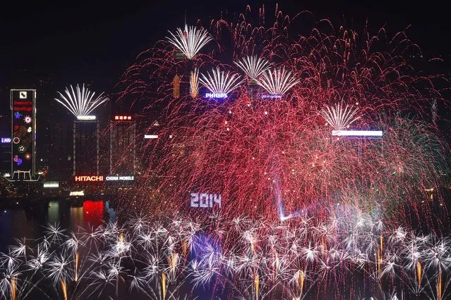 Fireworks explode at the Hong Kong Convention and Exhibition Centre. (Photo by Kin Cheung/Associated Press)