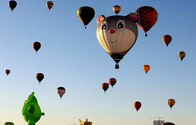 Hot air balloons fly during the third day of the 21st International Hot Air Balloon Festival in Leon, Guanajuato state, Mexico, on November 19, 2023. (Photo by Ulises Ruiz/AFP Photo)