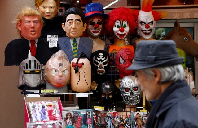 A man walks past a shop selling masks of U.S. President Donald Trump (L top)  and Japanese Prime Minister Shinzo Abe at a market street in Tokyo, Japan January 23, 2017. (Photo by Kim Kyung-Hoon/Reuters)