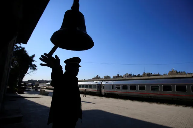 A Station master rings the bell at Baghdad Station in west Aleppo, Syria February 1, 2017. (Photo by Ali Hashisho/Reuters)