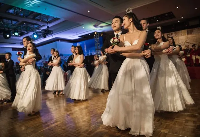 Chinese and foreign debutantes dance during the Vienna Ball at the Kempinski Hotel, March 19, 2016, in Beijing. (Photo by Kevin Frayer/Getty Images)