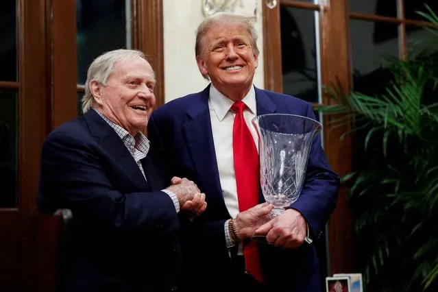 Republican presidential candidate and former U.S. President Donald Trump receives a trophy as the Most Improved Player from Jack Nicklaus, a retired American professional golfer, during the 2024 Senior Club Championship award ceremony at his Trump International Golf Club in West Palm Beach, Florida on March 25, 2024. (Photo by Marco Bello/Reuters)