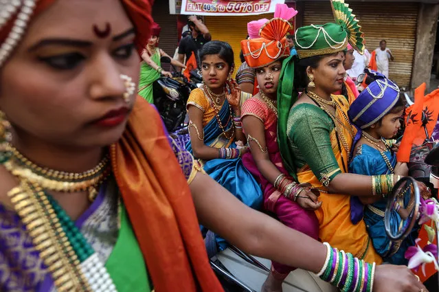 Indian people in traditional clothes participate in the procession to celebrate the Gudi Padwa, Maharashtrian's New Year in Mumbai, India, 08 April 2016. Gudi Padwa is the Hindu festival that falls on the first day of Chaitra month and marks the beginning of the Lunar Calendar, which dictates the dates for all Hindu festivals, also known as Panchang. (Photo by Divyakant Solanki/EPA)