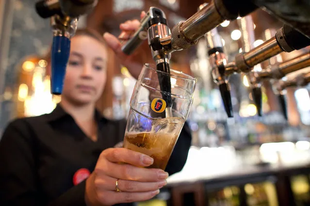 A bartender pours a pint of Fosters lager at The Knights Templar public house, operated by JD Wetherspoon Plc, in London, U.K., on Wednesday, September 7, 2011. (Photo by Simon Dawson/Bloomberg via Getty Images)
