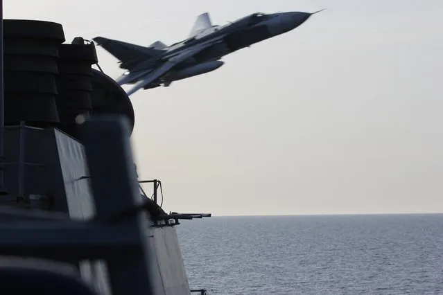 In this image released by the U.S. Navy, a Russian SU-24 jet makes a close-range and low altitude pass near the USS Donald Cook on Tuesday, April 12, 2016, in the Baltic Sea. The Russian attack planes buzzed the U.S. Navy destroyer multiple times on Monday and Tuesday, at one point coming so close, an estimated 30 feet, that they created wakes in the water around the ship, a U.S. official said Wednesday, April 13. (Photo by U.S. Navy via AP Photo)