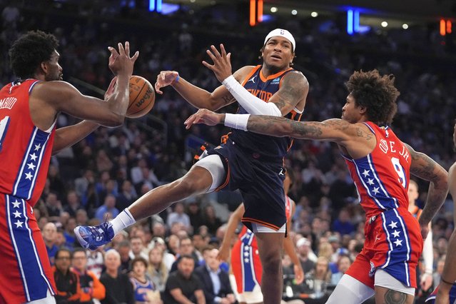 Philadelphia 76ers' Kelly Oubre Jr., right, knocks the ball away from New York Knicks' Miles McBride, center, as 76ers' Joel Embiid, left, defends during the second half of Game 2 in an NBA basketball first-round playoff series Monday, April 22, 2024, in New York. (Photo by Frank Franklin II/AP Photo)