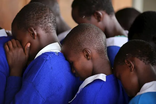 Students rehearse a poem that they will have to perform to an audience, moments before the start of a social event advocating against harmful practices such as Female Genital Mutilation (FGM) at the Imbirikani Girls High School in Imbirikani, Kenya, April 21, 2016. (Photo by Siegfried Modola/Reuters)
