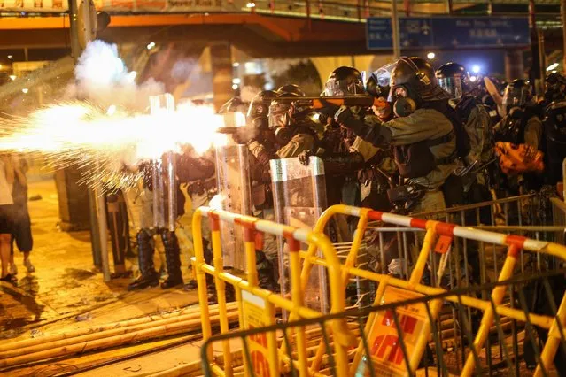Riot police fire tear gas to disperse protesters taking part in a rally against the police brutality in Hong Kong, China, 28 July 2019. Hong Kong has a new mass rally with demonstrators protesting against the police brutality on 27 July in Yuen Long, another mass protest was held and ended up with clashes between protesters and the police when riot police fired rubber bullets, tear gas and pepper spray to disperse the crowd. (Photo by Jerome Favre/EPA/EFE)