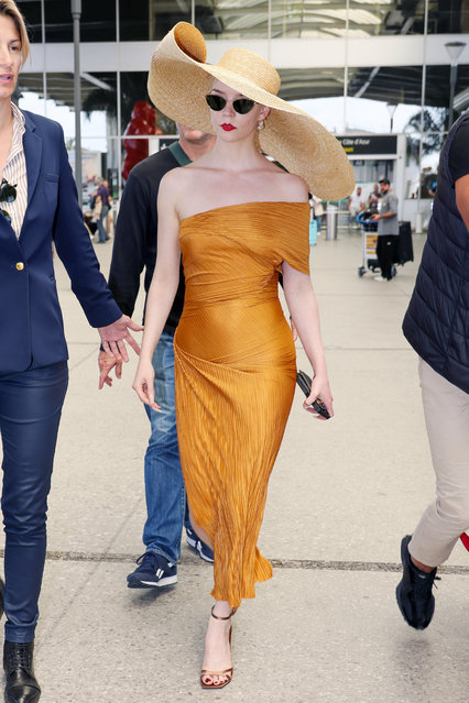 Anya Taylor Joy is seen arriving ahead of the 77th annual Cannes film festival at Nice Airport on May 13, 2024 in Nice, France. The American actress looked styling in an oversized straw sun hat, paired with a gold dress, and matching heels. (Photo by The Image Direct)