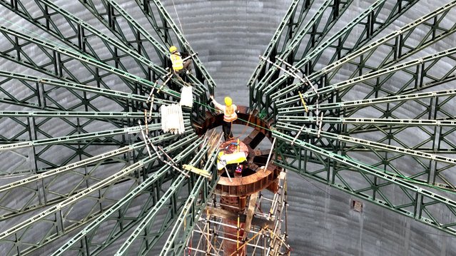 Builders are working on a grain storage warehouse lifting tower in Nantong, Jiangsu province, China, on May 27, 2024. (Photo by Costfoto/NurPhoto/Rex Features/Shutterstock)