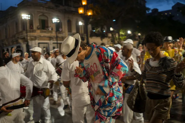 Models dance after the presentation of fashion designer Karl Lagerfeld's “cruise” line for fashion house Chanel, at the Paseo del Prado street in Havana, Cuba, Tuesday, May 3, 2016. (Photo by Ramon Espinosa/AP Photo)