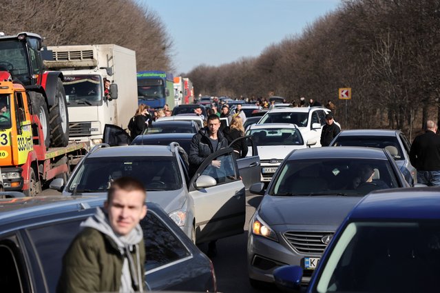 People wait in a traffic jam as they leave the city of Kharkiv, after Russian President Vladimir Putin authorised a military operation in eastern Ukraine, in Kharkiv region, Ukraine on February 24, 2022. (Photo by Antonio Bronic/Reuters)