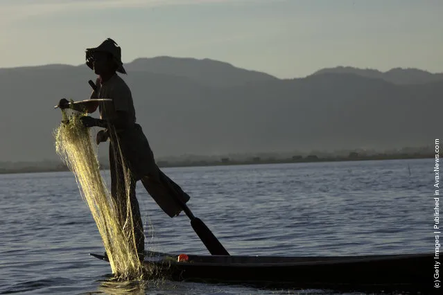 Intha leg rowing fishermen starts to fish in the early morning hours on Inle Lake in Myanmar