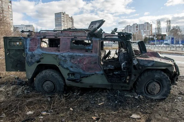 A damaged and burnt military vehicle is seen after fighting in Kharkiv, Ukraine, Sunday, February 27, 2022. The city authorities said that Ukrainian forces engaged in fighting with Russian troops that entered the country's second-largest city on Sunday. (Photo by Marienko Andrew/AP Photo)