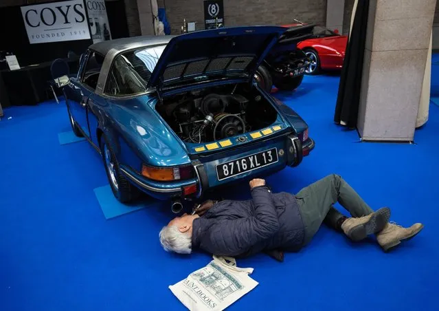 A man looks underneath a 1973 Porsche 911 Targa (estimate £55,000 - £65,000) at the Royal Horticultural Halls on April 11, 2017 in London, England. (Photo by Jack Taylor/Getty Images)
