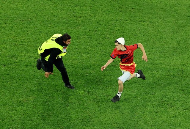 Pitch invader is chased by a steward during the Euro match between Albania and Spain in Dusseldorf, Germany on June 24, 2024. (Photo by Thilo Schmuelgen/Reuters)