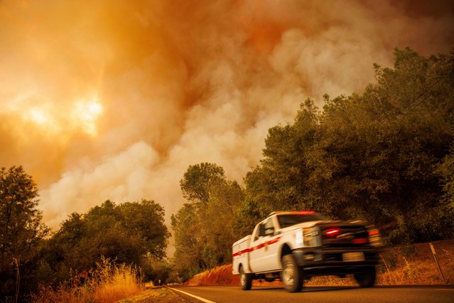 A firetruck passes as the Thompson Fire burns, Tuesday, July 2, 2024, in Oroville, Calif. (Photo by Ethan Swope/AP Photo)