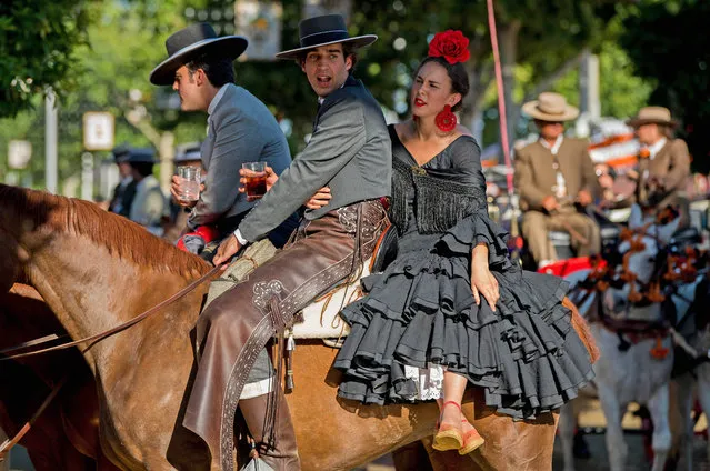 Participants in traditional dress ride on horseback as they enjoy the atmosphere at the Feria de Abril (April's Fair) on May 1, 2017 in Seville, Spain. (Photo by David Ramos/Getty Images)