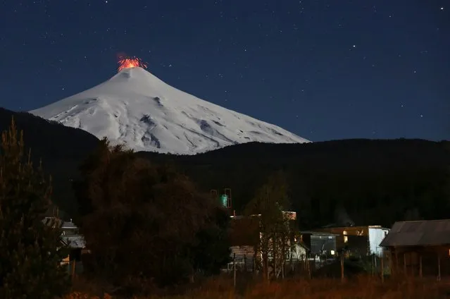 The Villarrica volcano spews lava at night, as seen from the town of Pucon, Chile on September 9, 2019. (Photo by Cristobal Saavedra/Reuters)