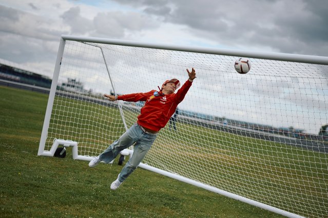 Ferrari's Monegasque driver Charles Leclerc plays football at the Silverstone motor racing circuit in Silverstone, central England, on July 4, 2024 ahead of the Formula One British Grand Prix. (Photo by Benjamin Cremel/AFP Photo)