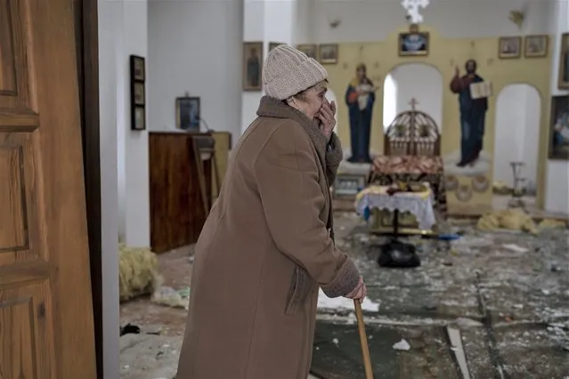 A woman reacts as she enters a damaged church following a Russian attack in the previous weeks, in the town of Makaro , Kyiv region Ukraine, on Sunday, April 10, 2022. Since the beginning of the war at least 59 spiritual sites, mostly Orthodox churches, have been ruined or damaged, the Ukrainian authorities said. (Photo by Petros Giannakouris/AP Photo)