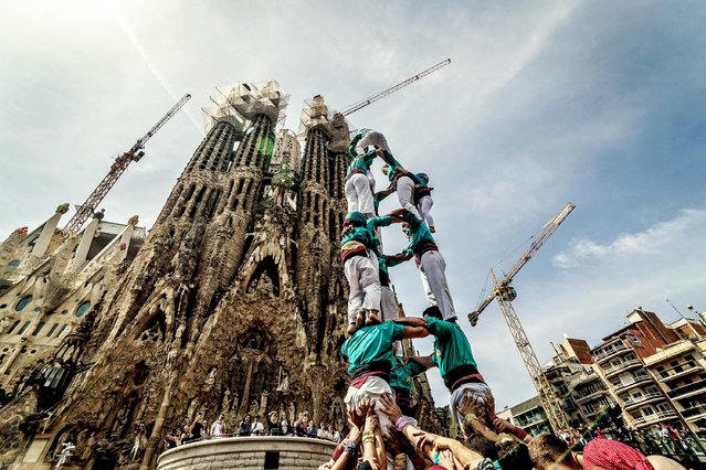 The “Castellers de la Sagrada Familia” build a human tower in front of Barcelona's Sagrada Familia in Spain on April 23, 2023. (Photo by Matthias Oesterle/Alamy Live News)